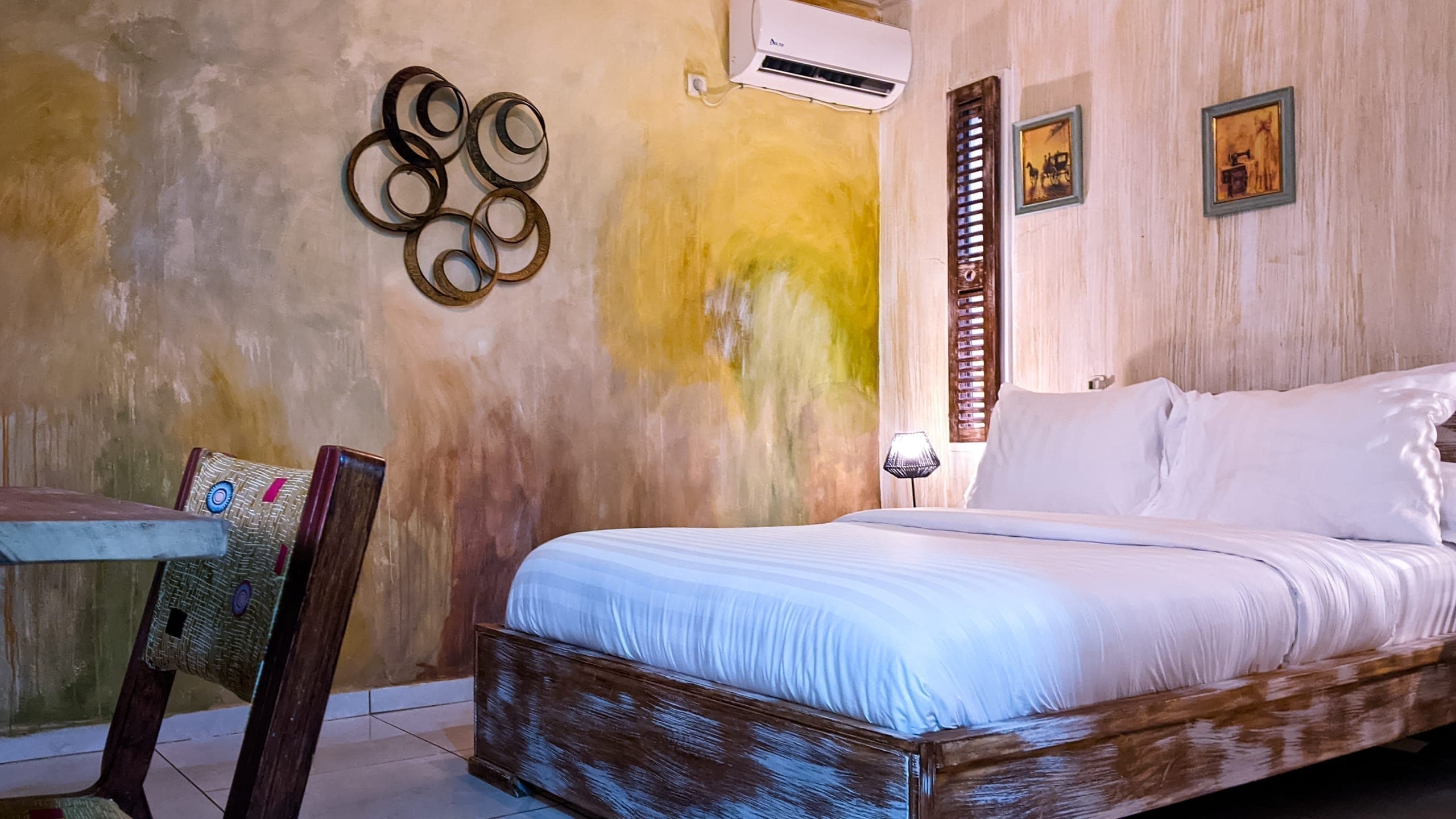 Bed beneath vintage-inspired wall art