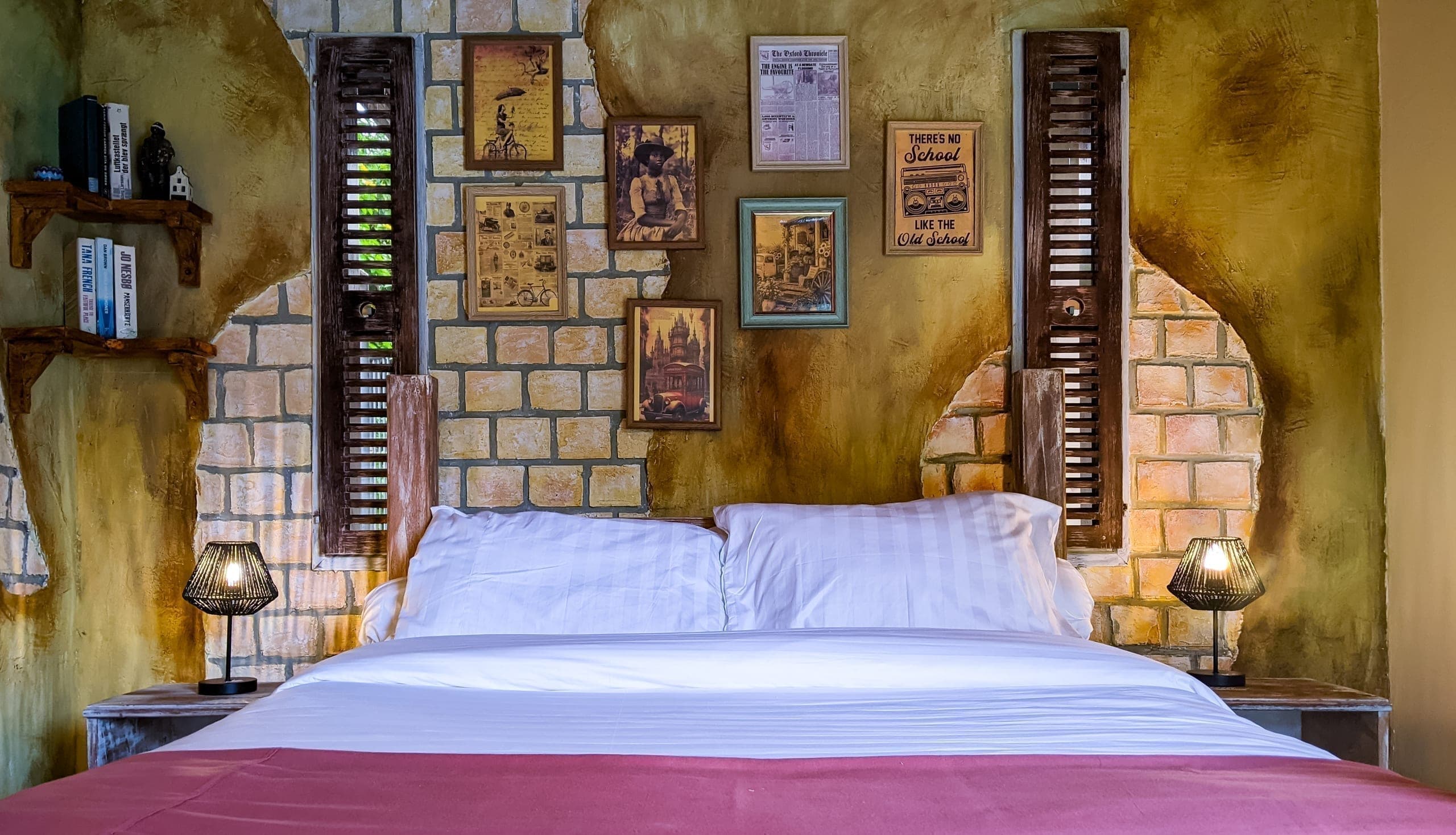 Bed dressed in earthy tones beneath handcrafted wall art