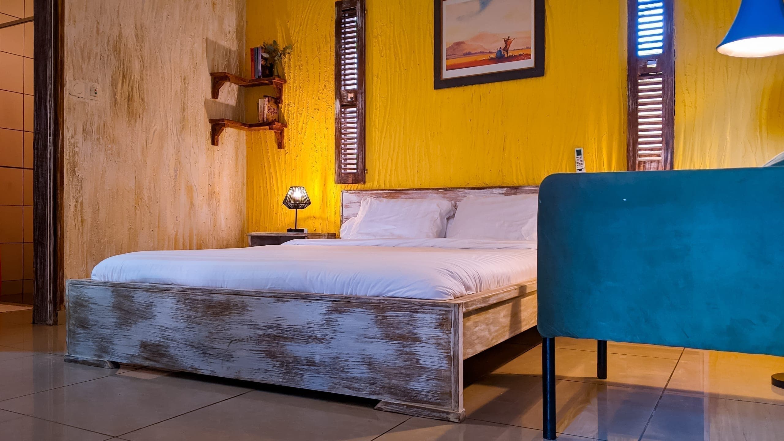 Wide view of the bed in warm ochre tones